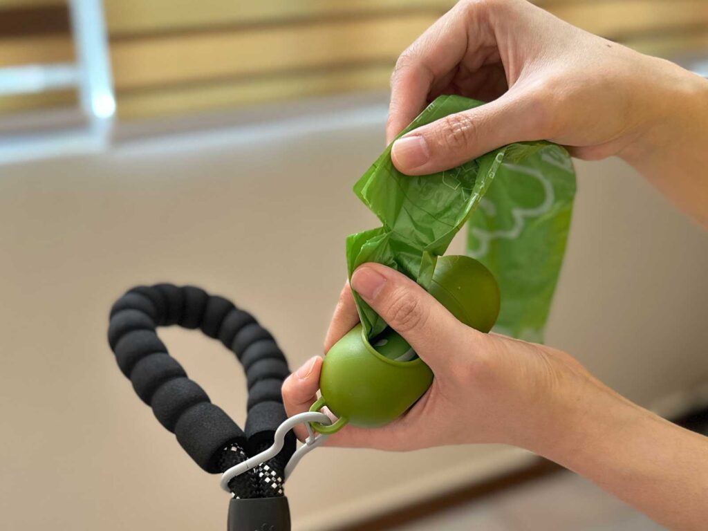 Cutting a dog poop bag along the perforated edge