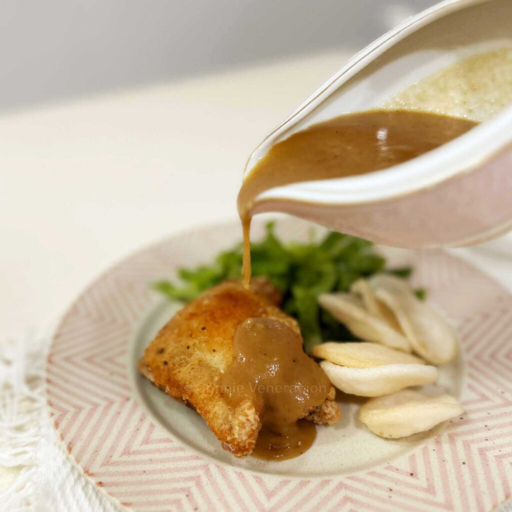 Pouring gravy over meat